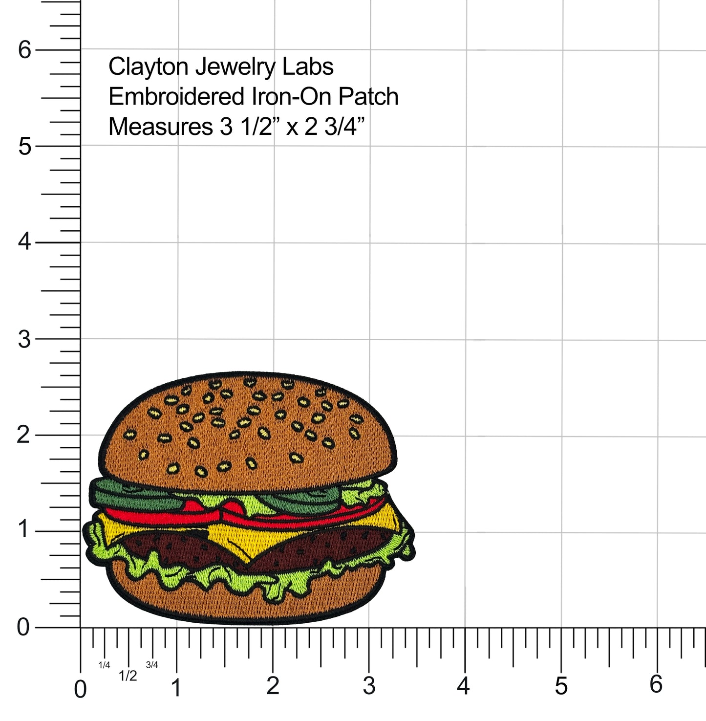 Embroidered iron-on patch of a hamburger with a ruler for scale on a white background