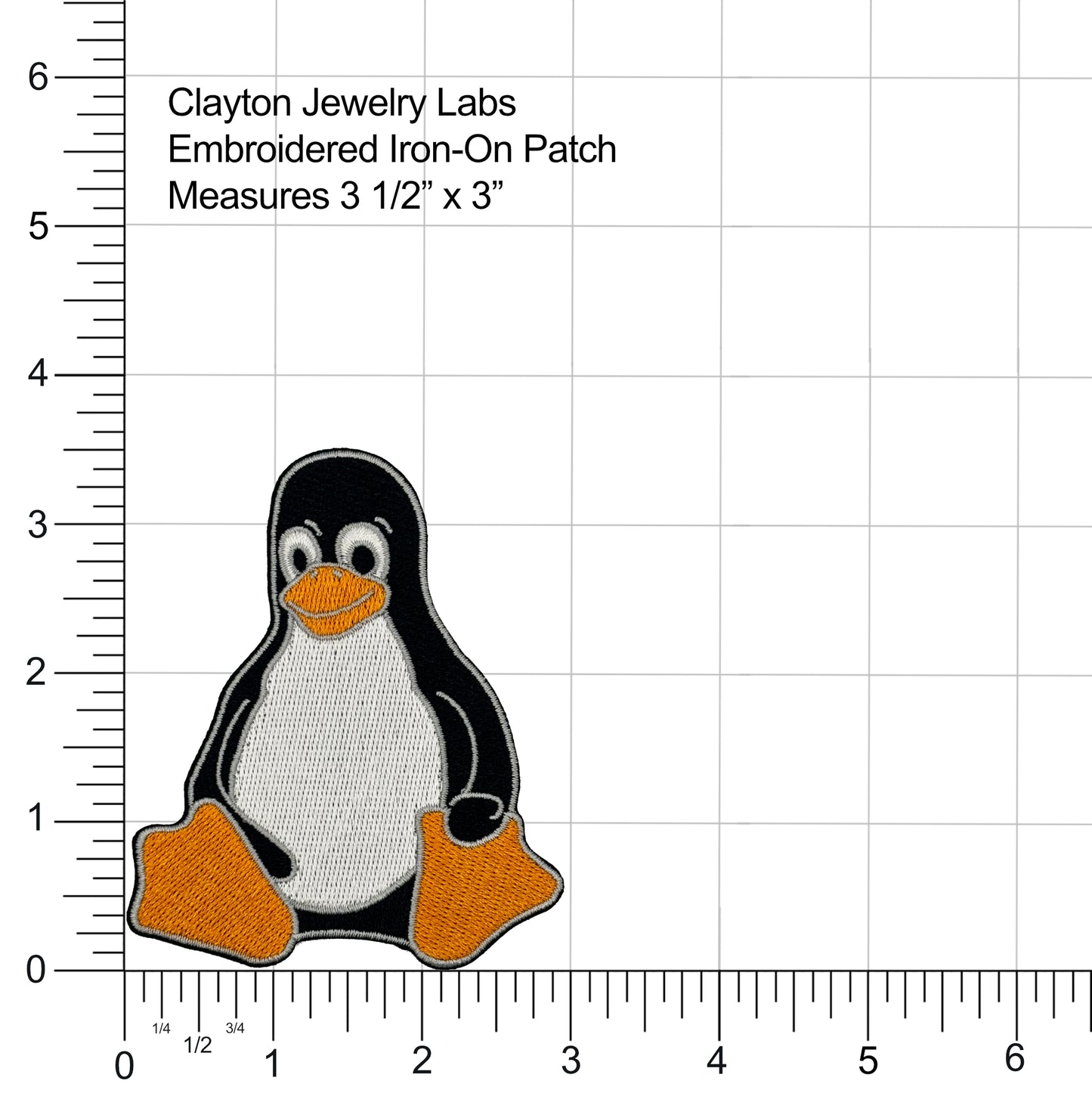 Embroidered iron-on patch of Tux the Linux Penguin with a ruler for scale on a white background
