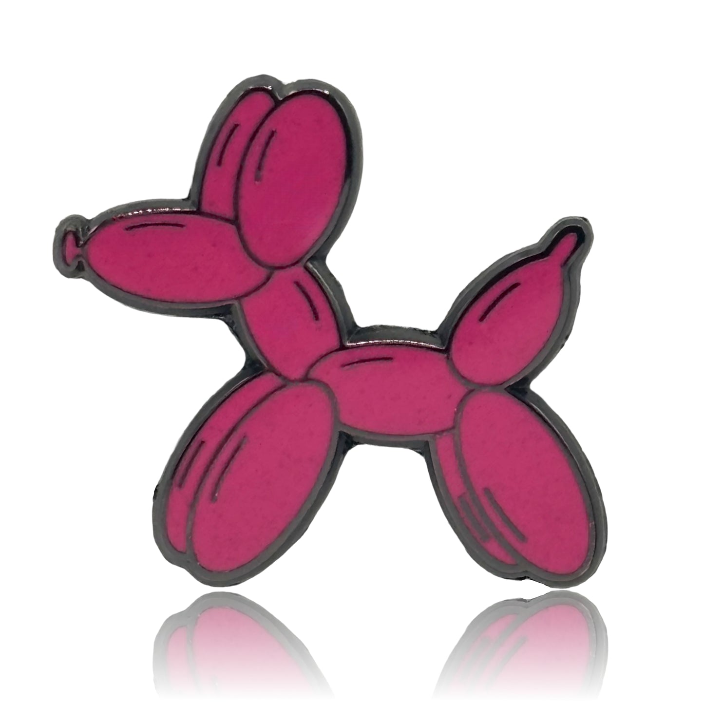 a pink poodle pin sitting on top of a white surface