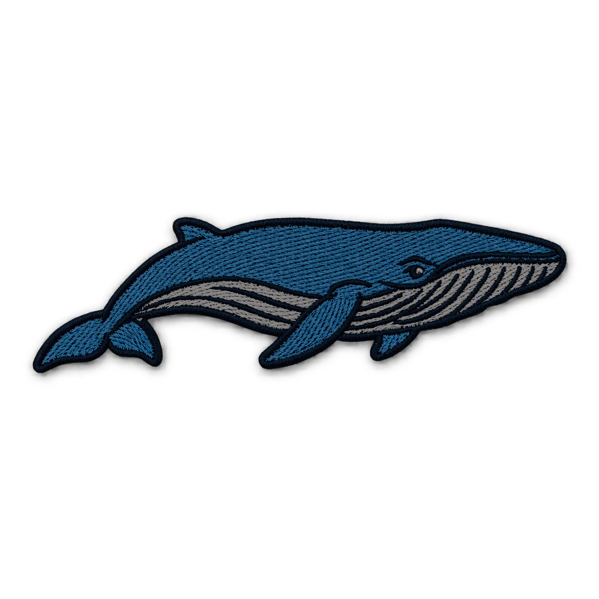 An embroidered blue whale patch in shades of blue and gray with a black stitched border, shown on a plain white background.