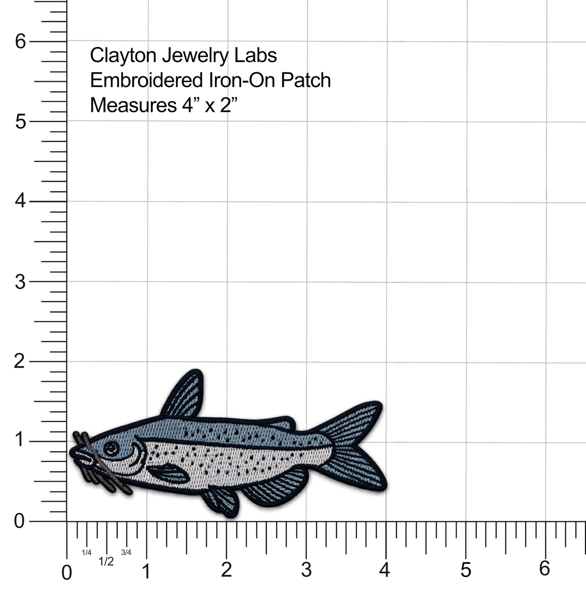 An embroidered iron-on patch of a channel catfish fish with a gray-blue body, black outlines, and small yellow accents, shown on a white background with measurement rulers and text reading 'Clayton Jewelry Labs Embroidered Iron-On Patch Measures 4" x 2"'.