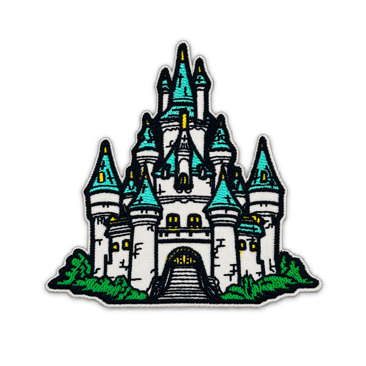 An embroidered patch featuring a stylized white castle with turquoise-blue spires, green grass, and yellow window lights on a white background.