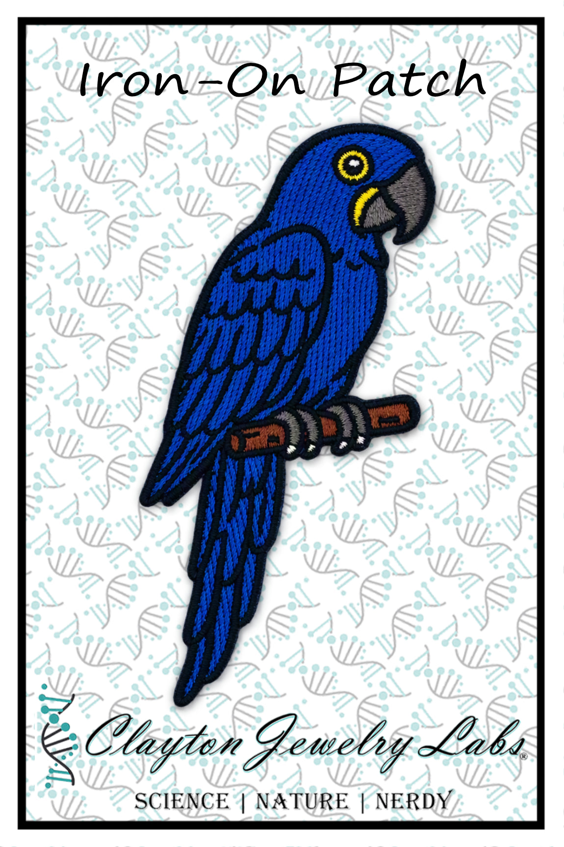 An embroidered iron-on patch featuring a blue parrot perched on a branch, with the text 'Iron-On Patch' at the top and 'Clayton Jewelry Labs' at the bottom on a white patterned background.