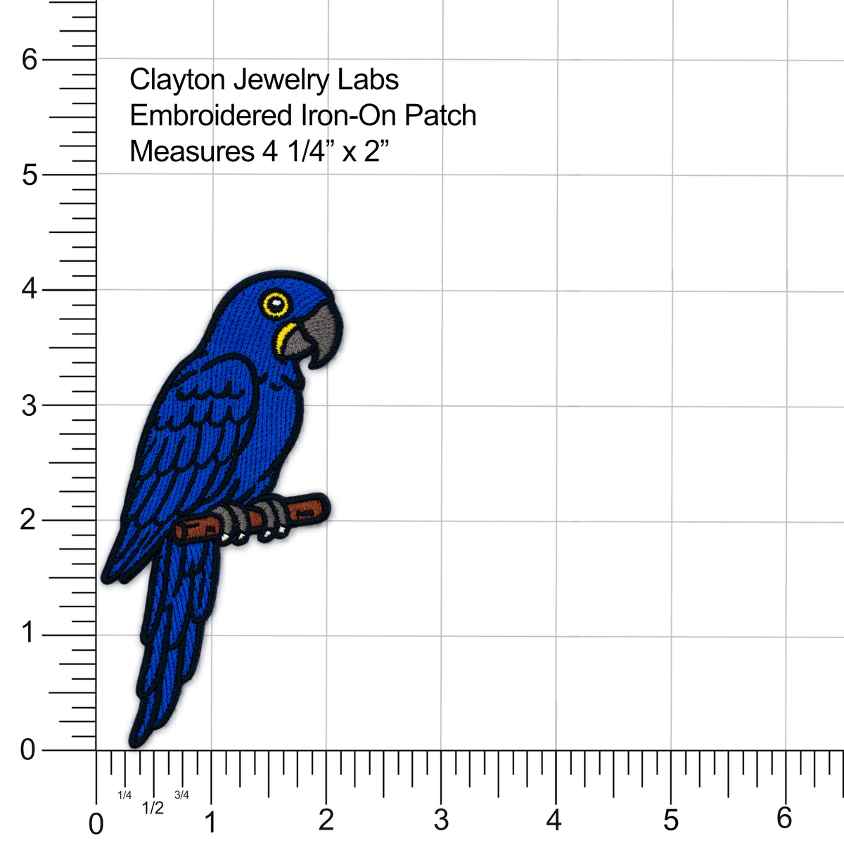 Embroidered iron-on patch of a blue parrot on a branch, shown with measurement rulers and text reading 'Clayton Jewelry Labs Embroidered Iron-On Patch Measures 4 1/4" x 2"' on a white background.