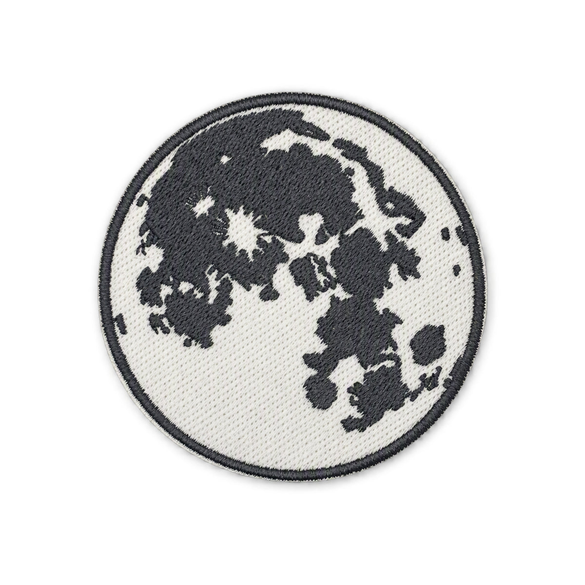 A circular embroidered patch depicting the moon with dark gray craters on a white background, finished with a dark gray stitched border, shown on a plain white background.