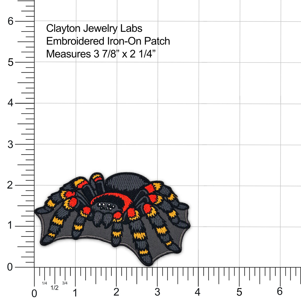 Spider-shaped embroidered iron-on patch by Clayton Jewelry Labs, shown on a white measurement grid with ruler markings and text indicating dimensions 3 7/8" x 2 1/4".