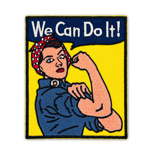 Embroidered patch featuring the iconic Rosie the Riveter flexing her bicep with the text 'We Can Do It!' in white on a dark blue banner, set against a bright yellow background with a black stitched border.