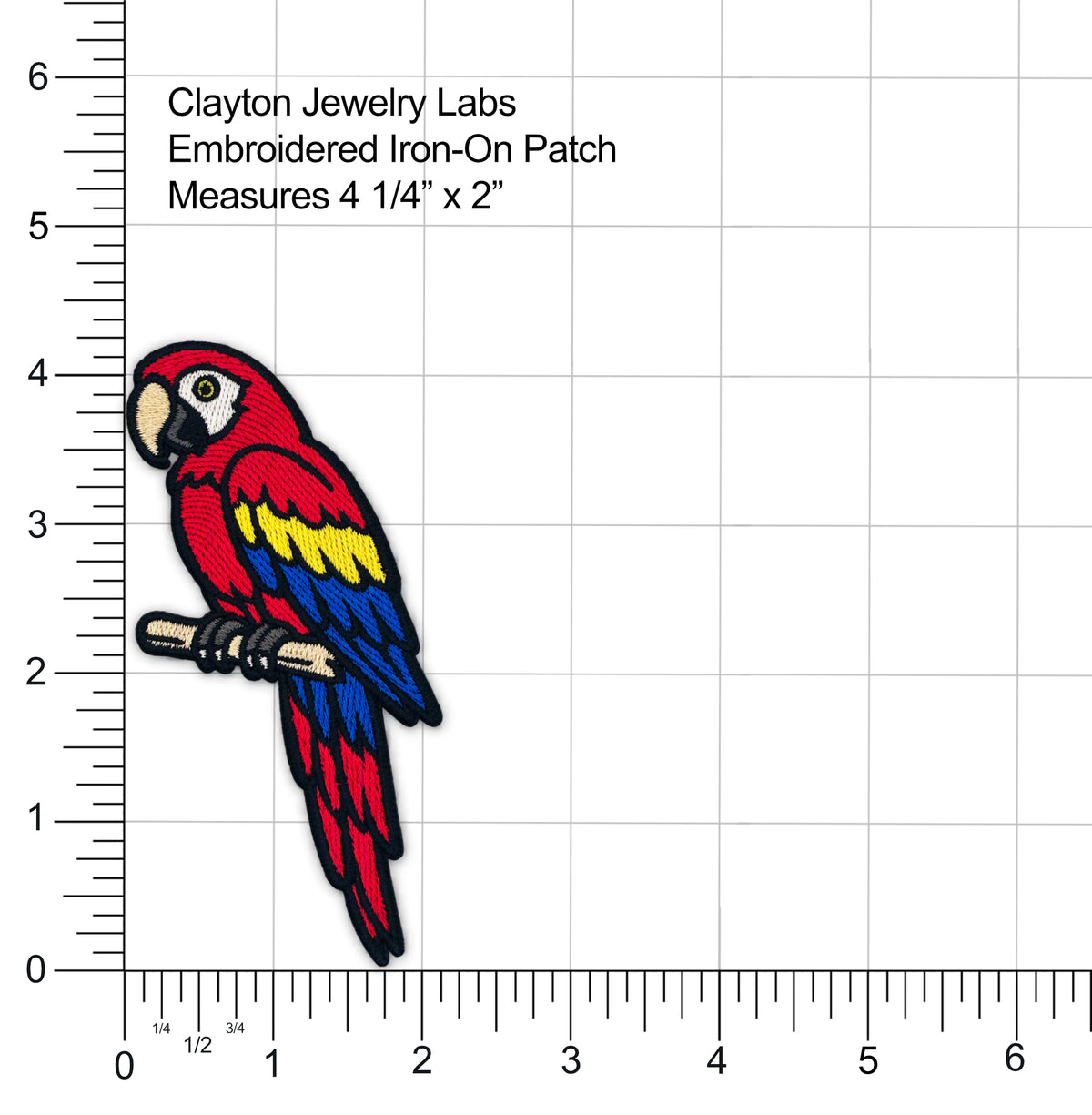 Embroidered iron-on patch of a colorful parrot on a ruler grid background with measurement text reading 'Clayton Jewelry Labs Embroidered Iron-On Patch Measures 4 1/4" x 2"'.