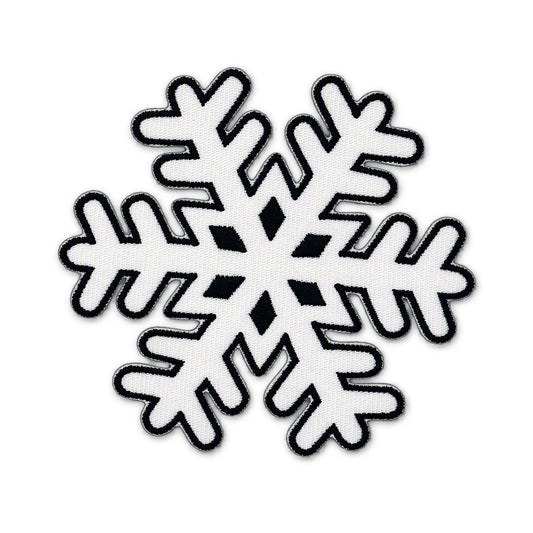 A single snowflake-shaped patch or applique on a plain white background. The design is white with a black embroidered outline and black diamond details in the center.