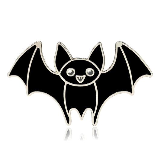 a black bat pin with a smile on it's face